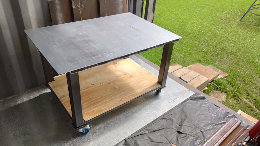 Steel workbench with removable cut-off saw.